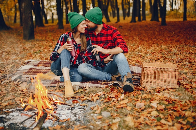 Elegant couple spend time in a autumn park