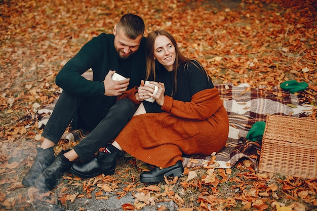 Elegant couple spend time in a autumn park