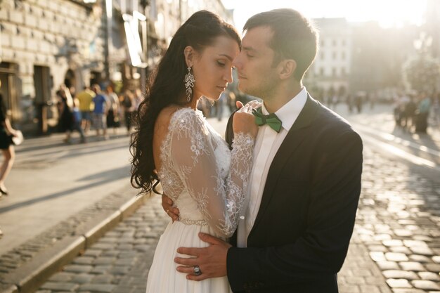 Elegant couple in wedding garments on street