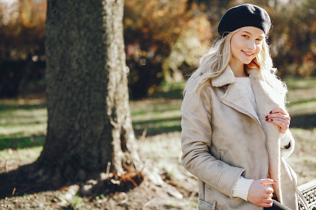 Elegant cute blonde in a autumn city