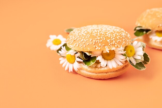 Free Photo elegant eco food concept with flowers in burger bun