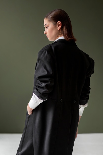 Elegant female model posing in a jacket suit with a tie. new feminity concept