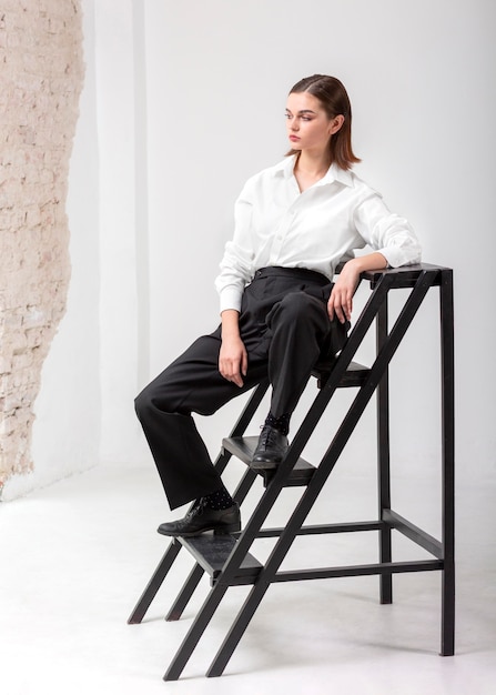 Elegant female model posing in stairs in a jacket suit. new feminity concept