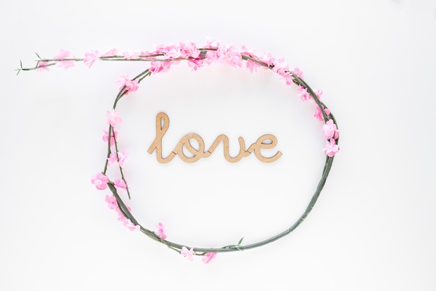 Free photo elegant flower wreath around love inscription