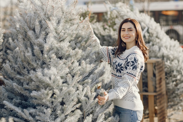 Free Photo elegant girl buys a christmas tree.