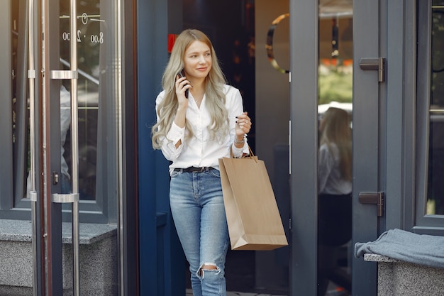 Elegant girl with shopping bag in a city