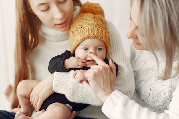 Free photo elegant grandma at home with daughter and grandson