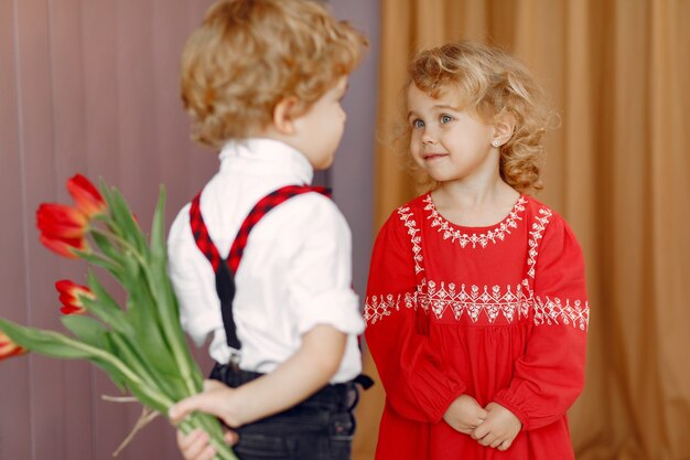 Elegant little kids with bouquet of tulip