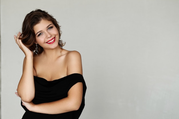 Elegant lovely woman posing with black dress