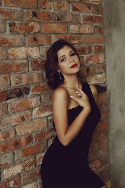 Elegant lovely woman posing with black dress