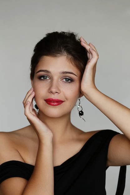 Elegant lovely woman posing with black dress