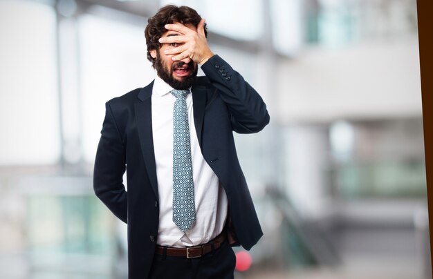 Elegant man covering his eyes