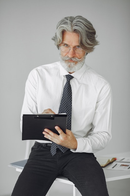 Free photo elegant man in office. businessman in white shirt. man works with documents.