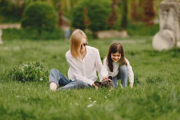 Elegant mother with daughter in a summer forest