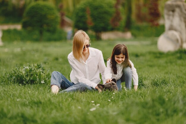 Elegant mother with daughter in a summer forest