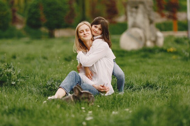 Elegant mother with daughter in a summer forest