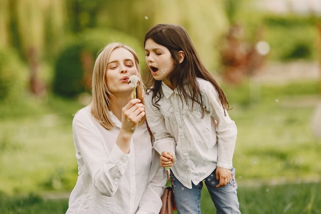 Elegant mother with daughter in a summer forest