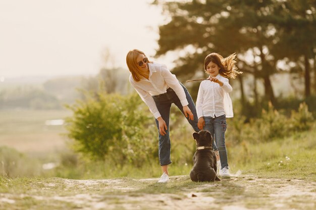 Elegant mother with daughter in a summer forest