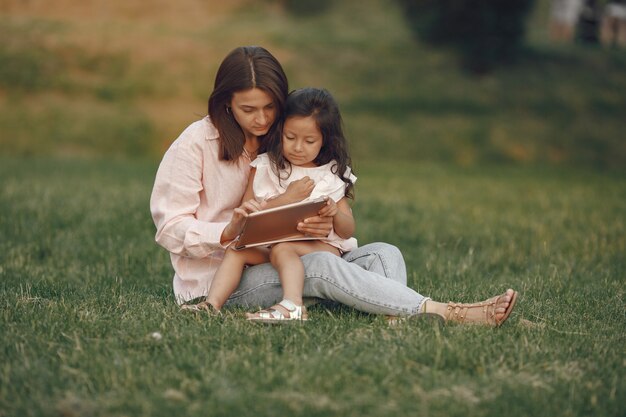 Elegant mother with daughter in a summer park