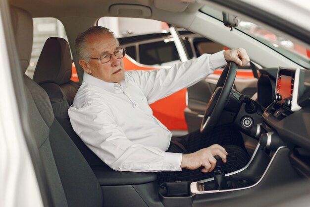 Elegant old man in a car salon