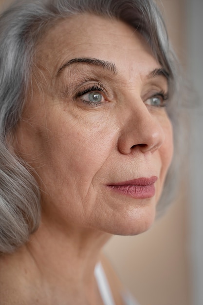 Elegant old woman wearing white clothes