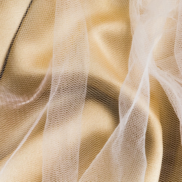 Free photo elegant pastel golden and transparent fabrics