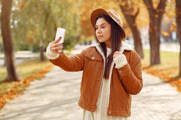 Elegant and stylish girl in a autumn park