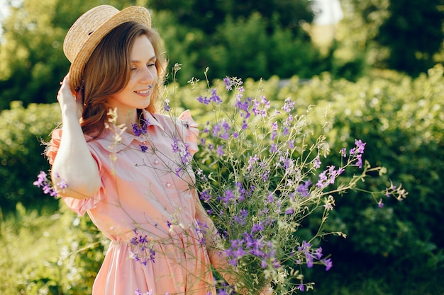 Elegant and stylish girl in a summer field