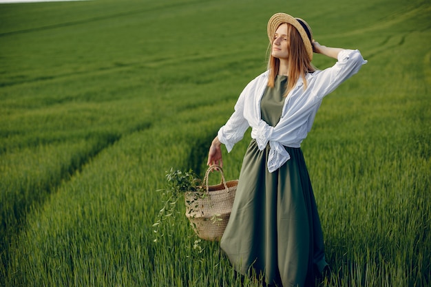 Elegant and stylish girl in a summer field