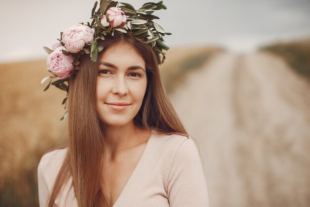 Elegant and stylish girl in a summer field