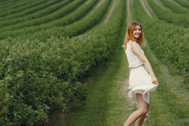 Elegant and stylish girl in a summer field