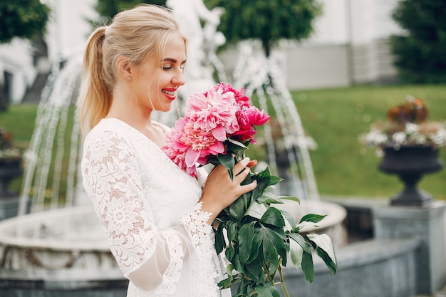 Elegant and stylish girl in a summer garden