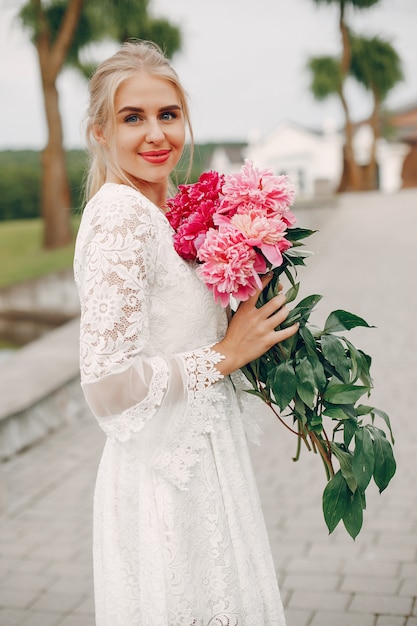 Elegant and stylish girl in a summer garden