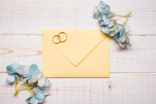 Elegant wedding rings on the table with flowers