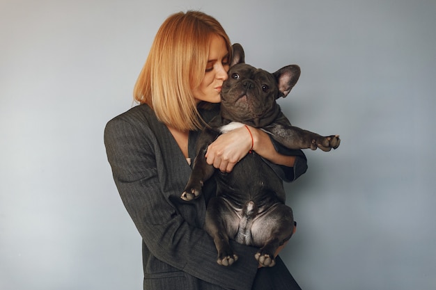 Free photo elegant woman in a black suit with black bulldog