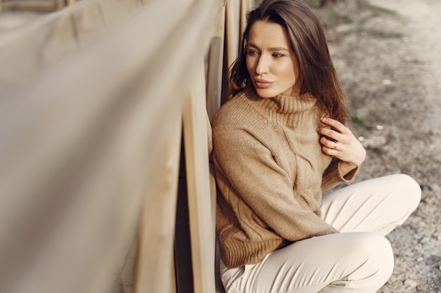 Free Photo elegant woman in a brown sweater in a spring city