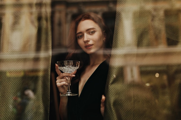 Free Photo elegant woman holds martini glass