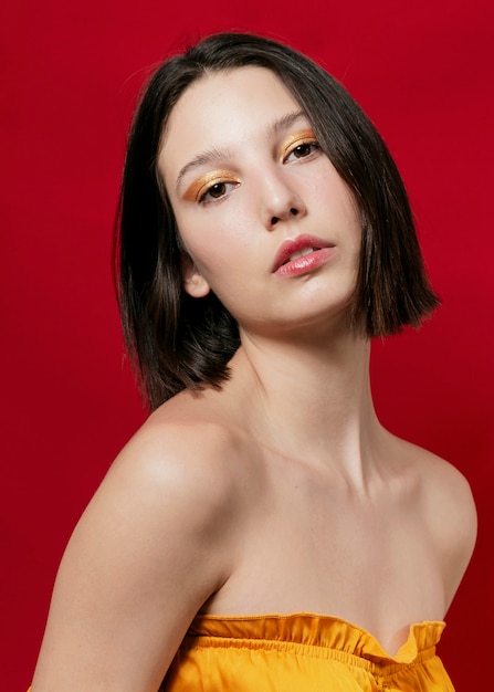 Elegant woman posing in yellow top