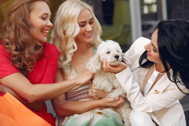 elegant women with little dog in a city