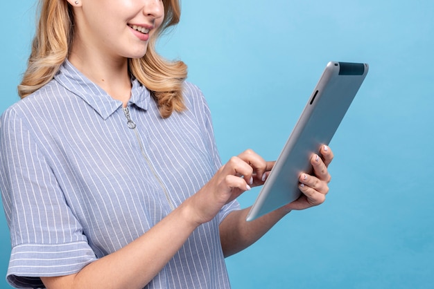 Elegant young woman browsing on a tablet