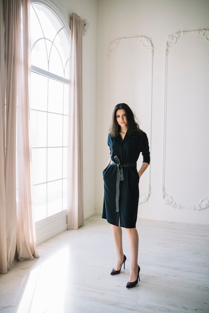 Free photo elegant young woman in dress in room