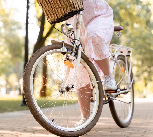 Elegant young woman riding bicycle