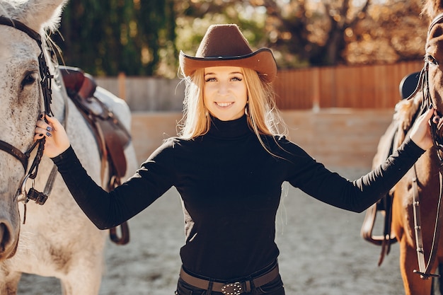 Free photo elegants girl with a horse in a ranch