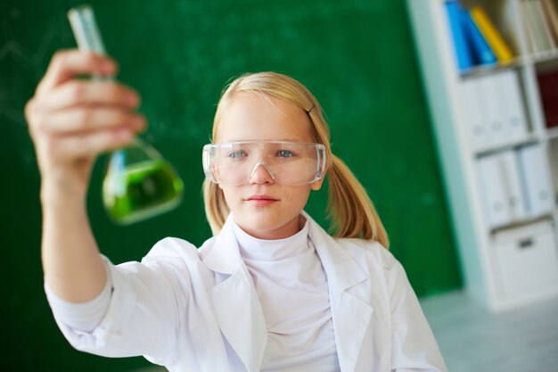 Elementary student analyzing the liquid