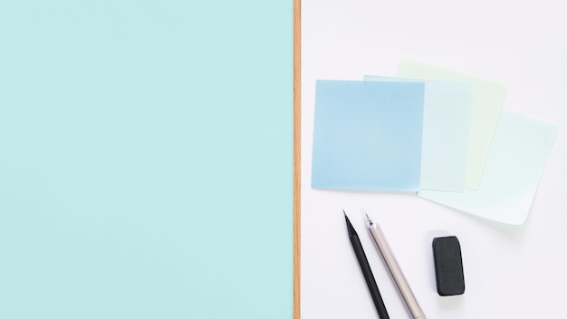 Free Photo elevated view of adhesive notes; pen; pencil and eraser on desk