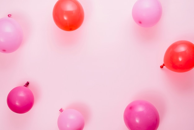 An elevated view of balloons against pink background