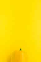 Free photo elevated view of bell pepper on yellow background