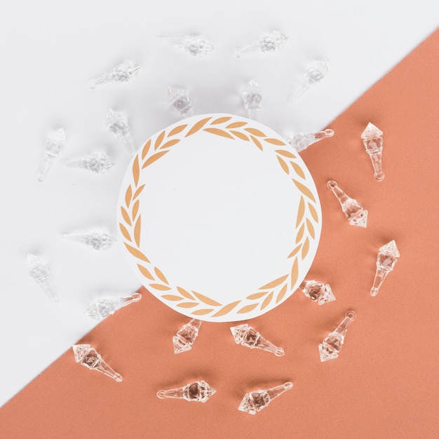 Free photo elevated view of blank round frame surrounded with crystal shells on dual background