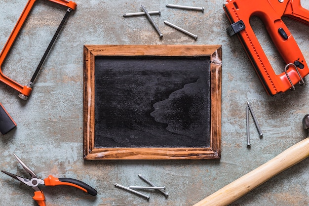 Elevated view of blank slate surrounded by various worktools