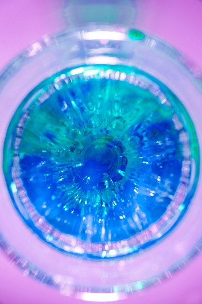 Free photo an elevated view of blue drink glass against pink background